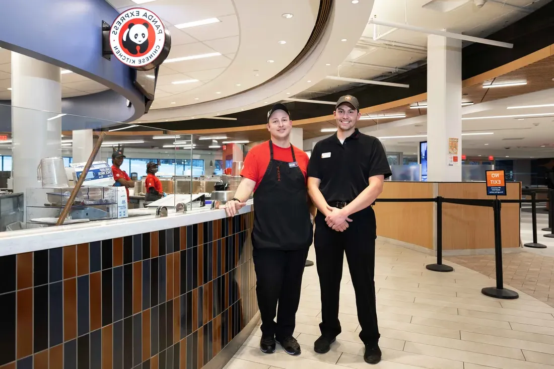 Campus Dining employees standing and smiling.